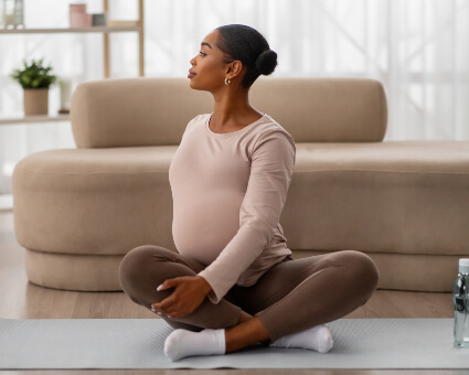 Pregnant woman sitting on a carpet