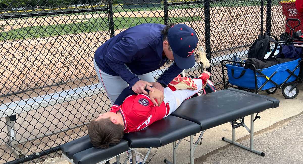 Dr. Brandon adjusting baseball player