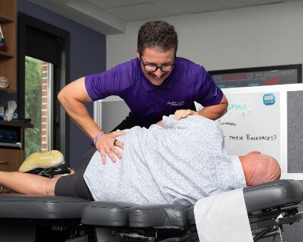 Chiropractor adjusting male patient