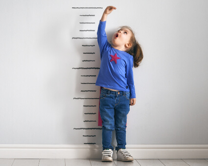 Little girl checking her height