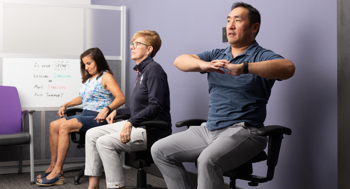 Chiropractor demonstrating corrective exercises