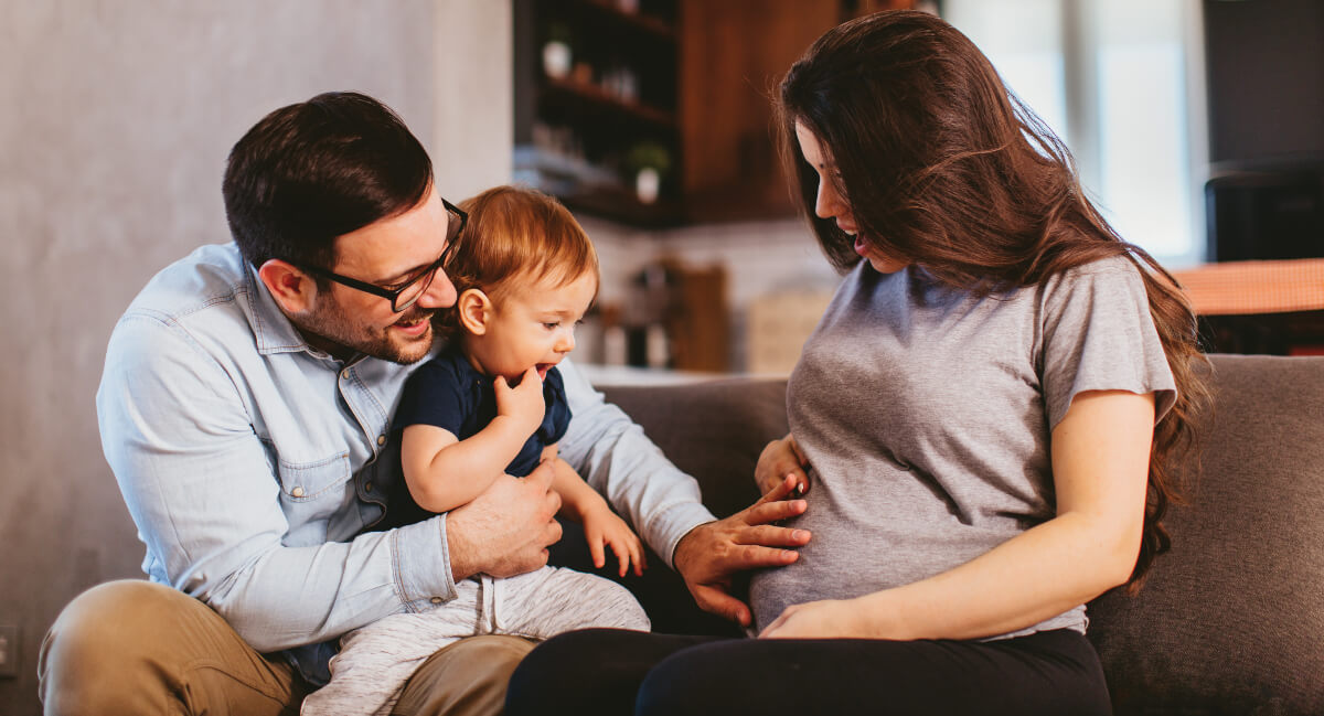 Pregnant mom with husband and young child