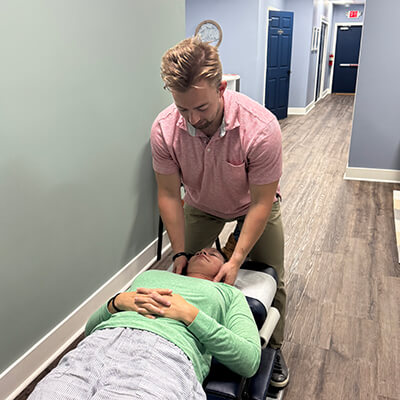 Dr Noah adjusting female patient