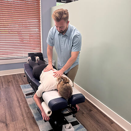 Dr. Noah adjusting female patient's back