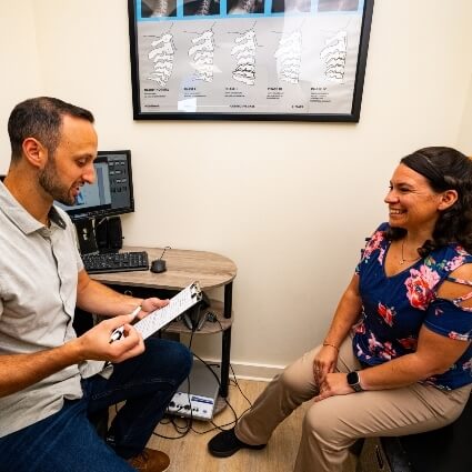Wappingers Falls chiropractor Dr Vallon talking with patient