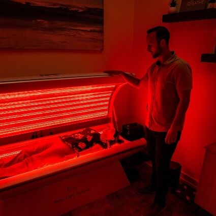 patient in red light therapy bed