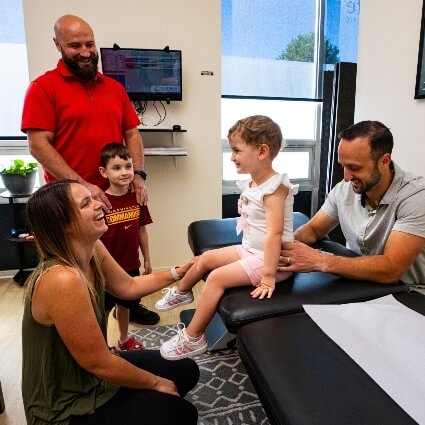 Dr Benjamin working with patient and family
