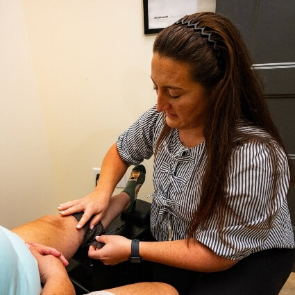 Dr Kristina placing tool on patients knee