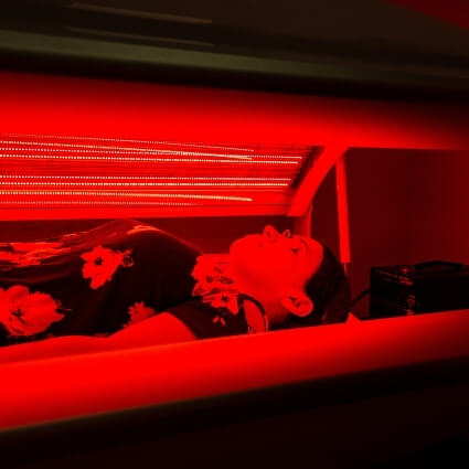 patient in red light therapy bed