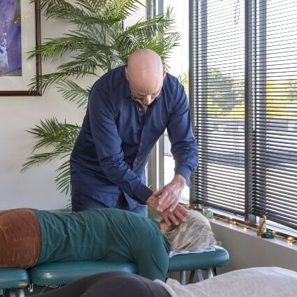 Dr Rick adjusting patients neck