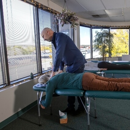 Dr Munn adjusting patients back