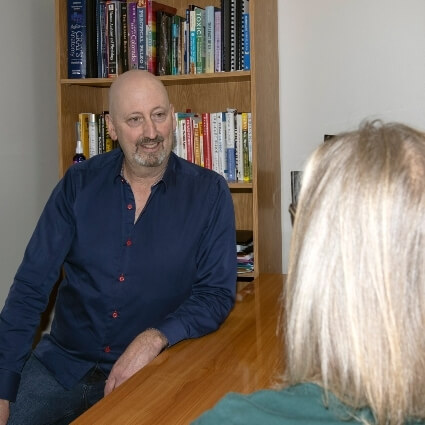 Lakewood chiropractor Dr Munn talking with patient