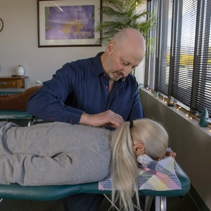 Dr Rick adjusting patients neck