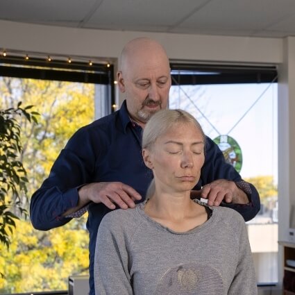 Dr Rick adjusting patients shoulders