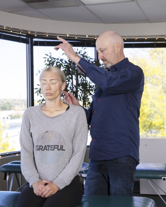 Colorado Health and Wellness Center patient having neck adjusted