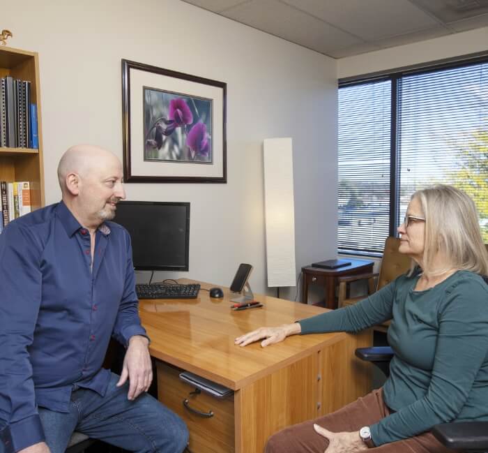 Lakewood chiropractor Dr Munn talking with a patient