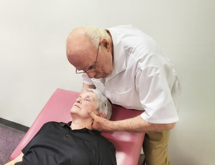 Dr. Wolverton adjusting a woman's neck.