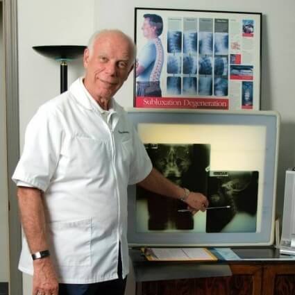 Baton Rouge chiropractor Dr Wolverton pointing at xrays