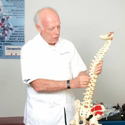 Baton Rouge chiropractor Dr Wolverton pointing at a spine model