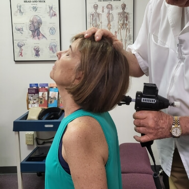 Baton Rouge patient having neck adjusted using a tool