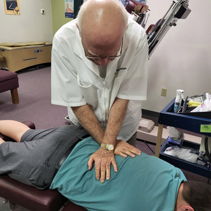 Dr. Wolverton adjusting a patient's lower back.