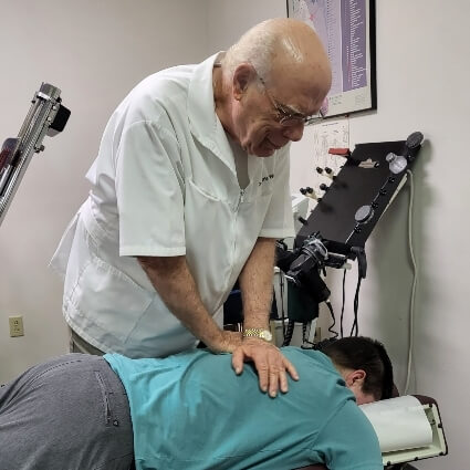 Community Chiropractic patient having upper back adjusted