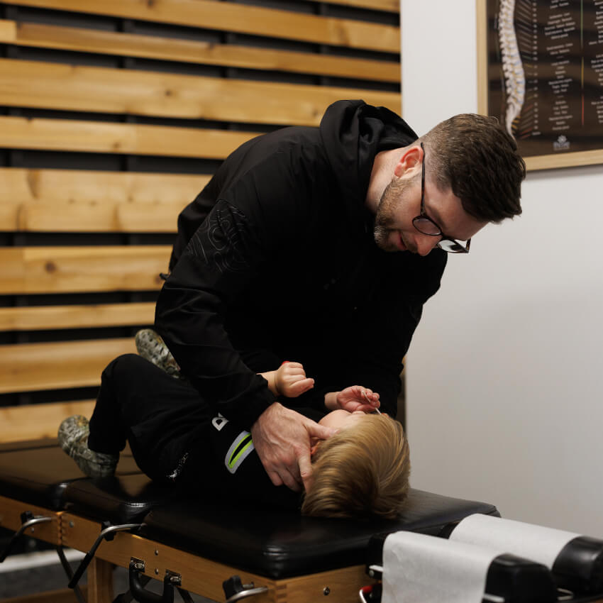 Dr Levi adjusting child patients