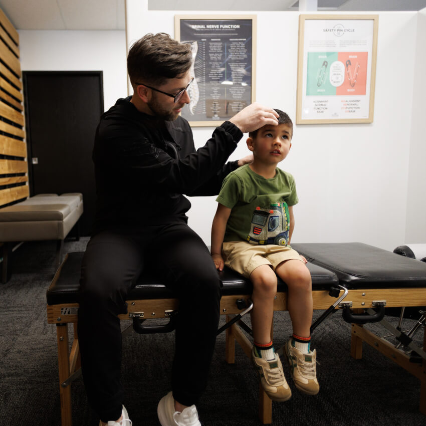 Dr Levi adjusting child patients neck
