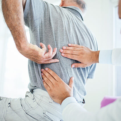 man having back examined