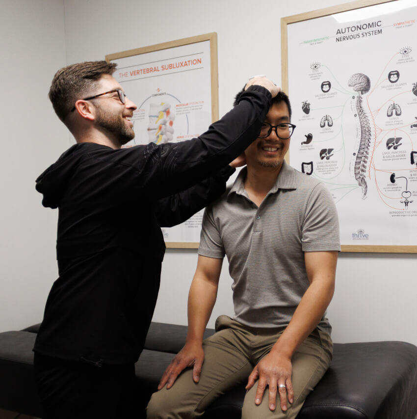 Rochester chiropractor Dr Levi examining patients neck