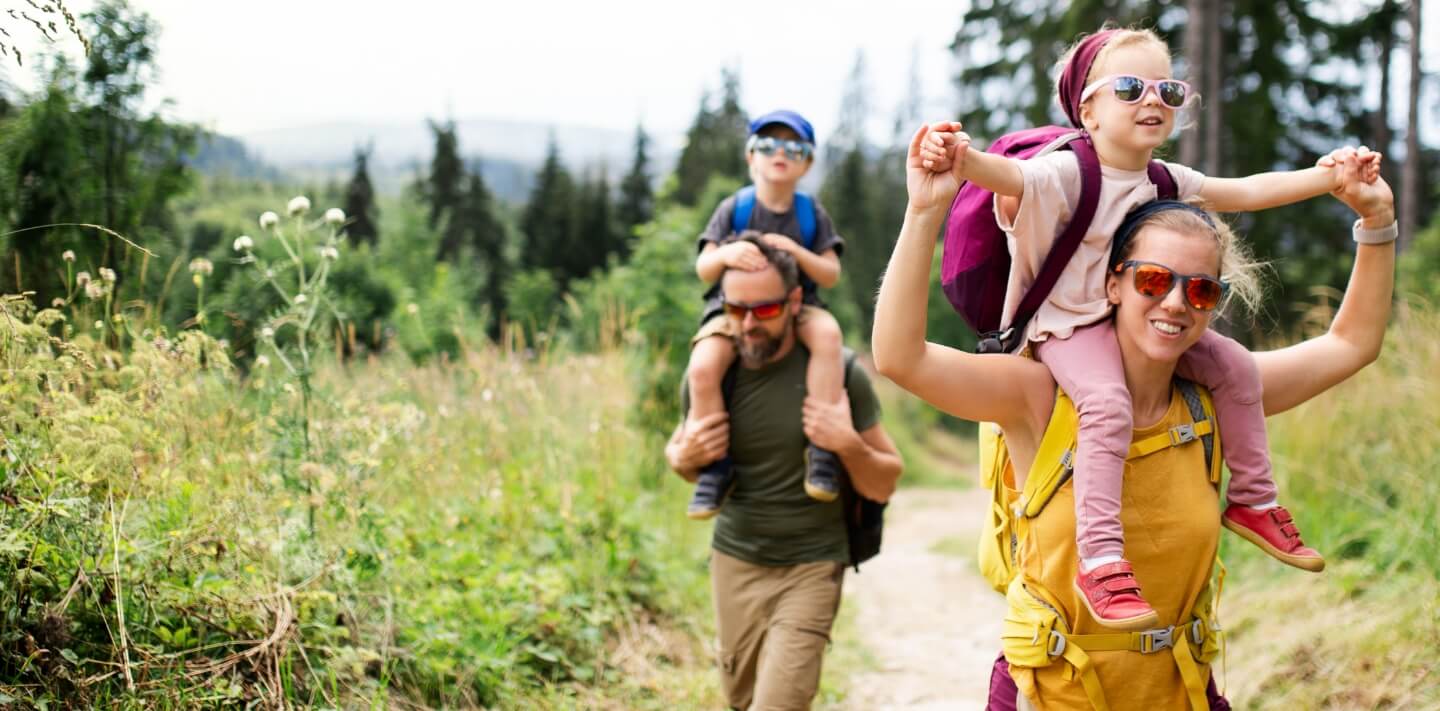family of 4 hiking in the forest