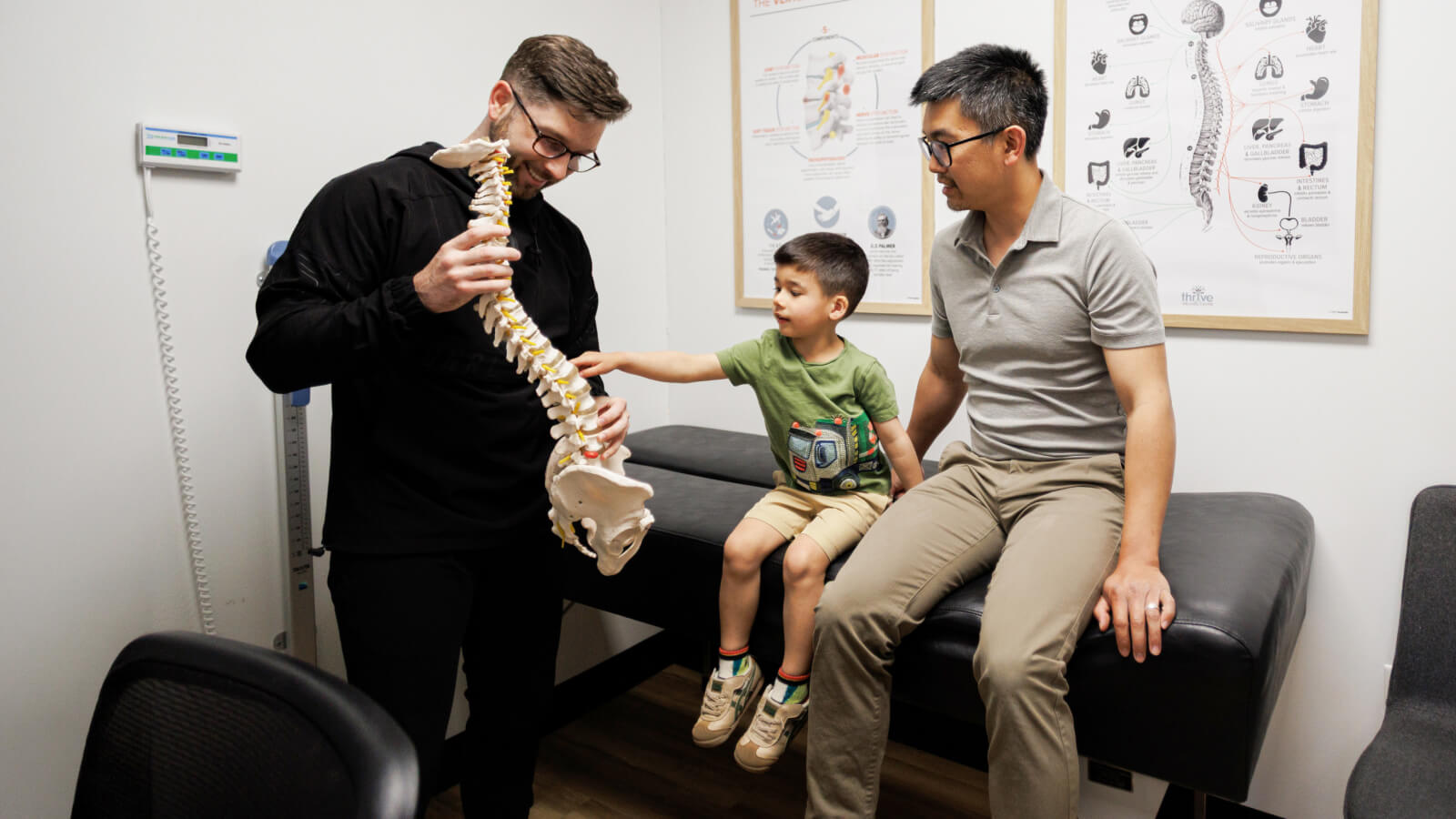 Doctor showing spine model to a kid patient
