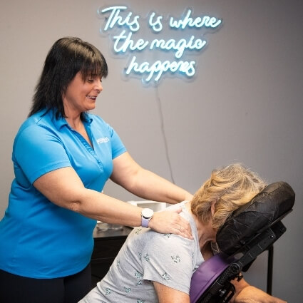 chiropractor adjusting patients back