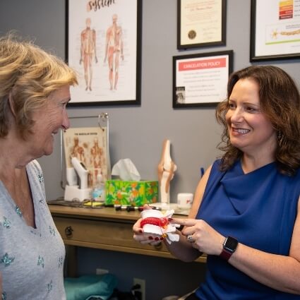 Dr Darin showing patient spine model