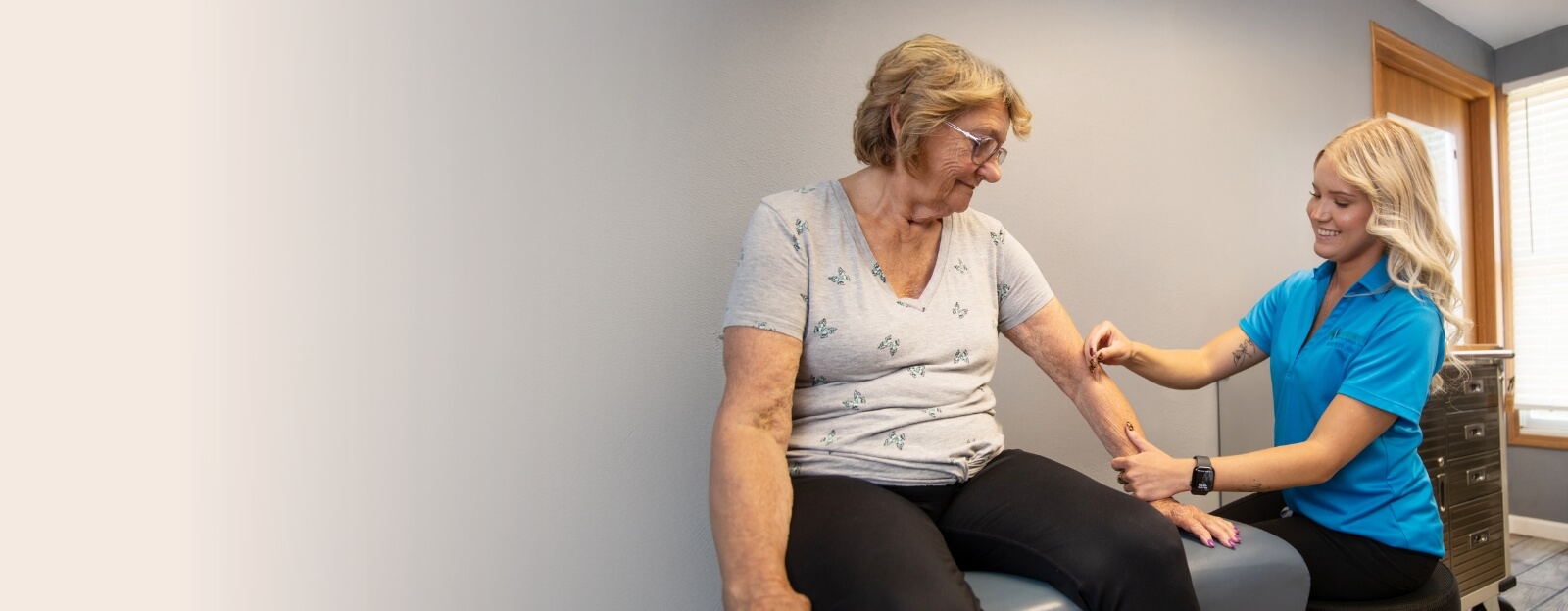 Granite City chiropractor examining patients arm