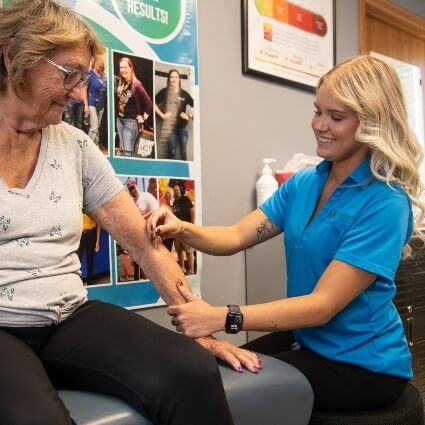 chiropractor touching patients arm