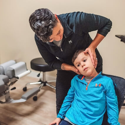 Dr Brandy adjusting childs neck