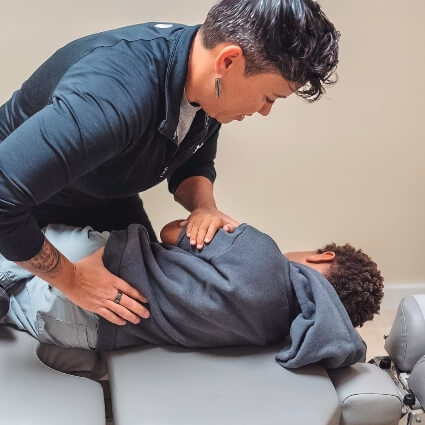 Dr Brandy adjusting childs back