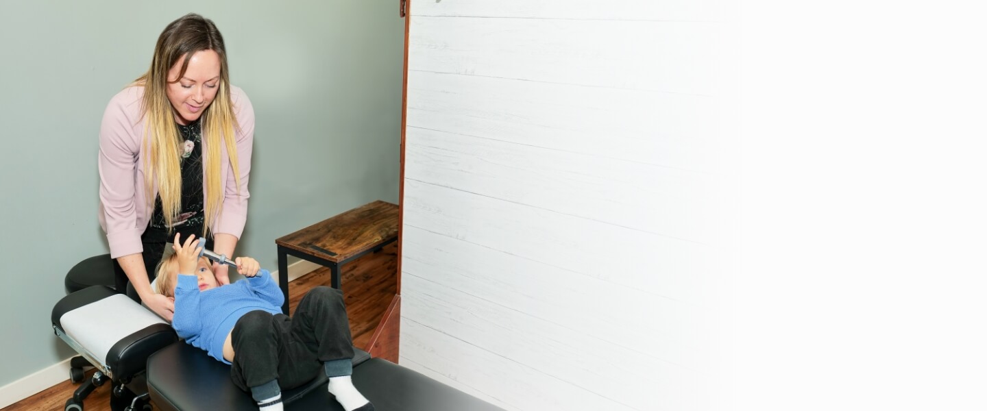 Dr. Keegan adjusting toddler on table