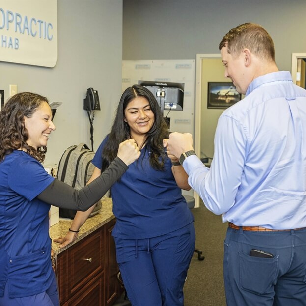 Doctor and staff fist bump