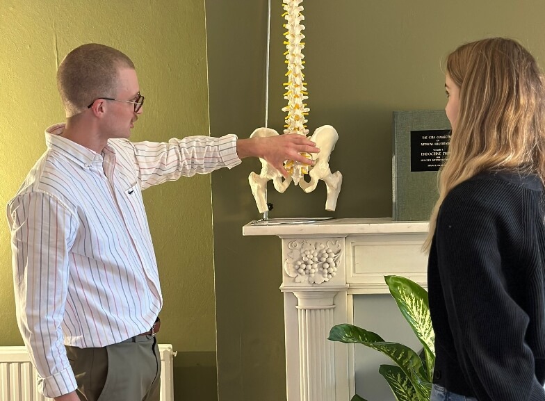 doctor pointing at spine model