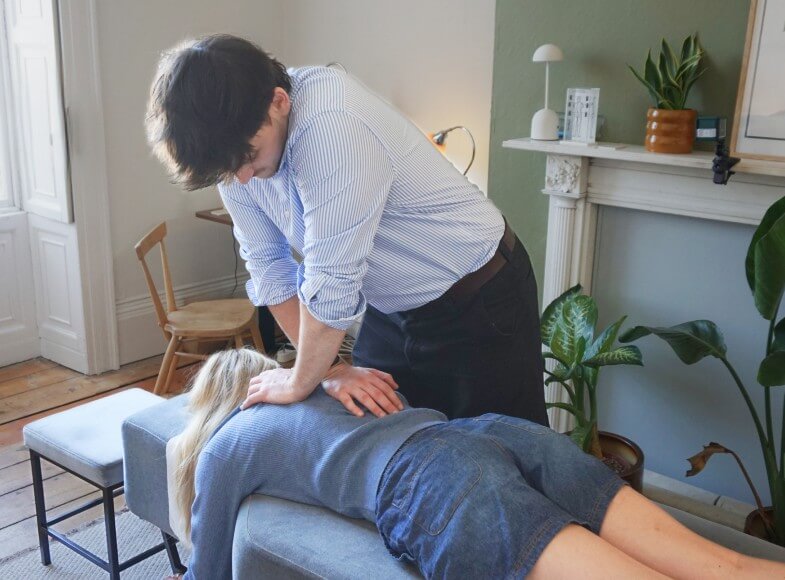 doctor pointing at spine model