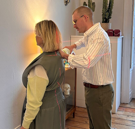 Bristol Chiropractor Callum Larcombe holding patients arm