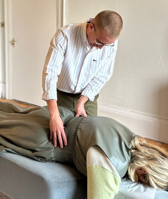 Chiropractor doing back adjustment