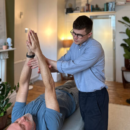 Dr. Max adjusting patient arms