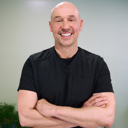 Stratham Chiropractor Dr. Bart Rzepa arms crossed