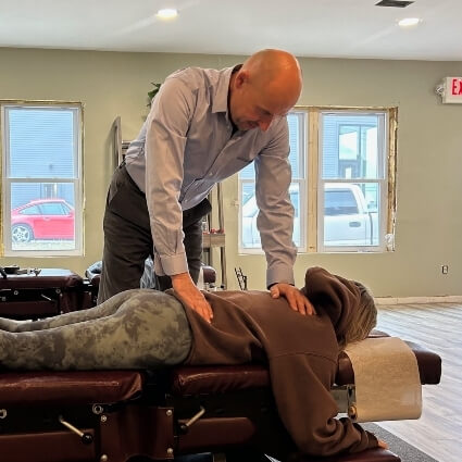 woman laying face down on adjusting table
