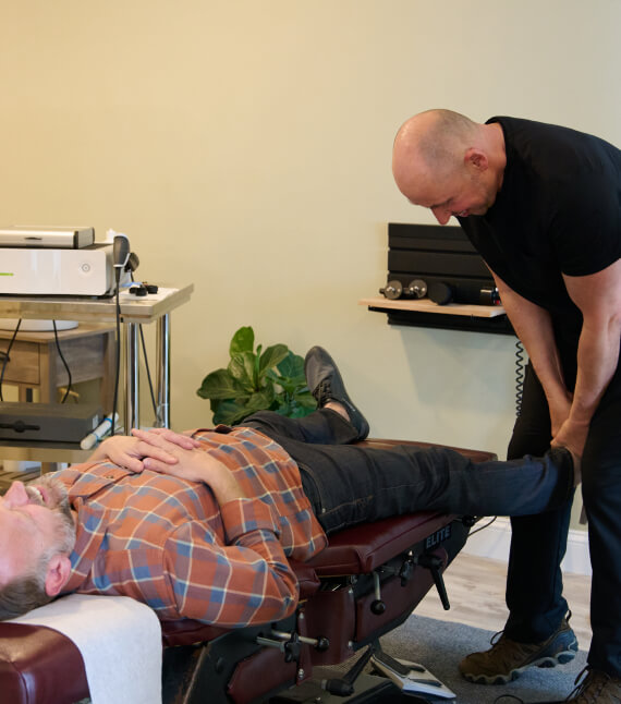 Stratham chiropractor Dr Rzepa adjusting patient's leg
