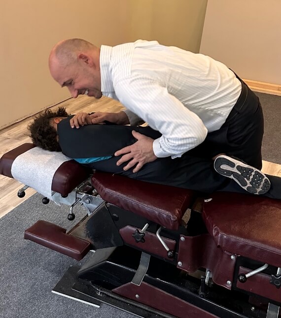 Stratham chiropractor Dr Rzepa adjusting kids back