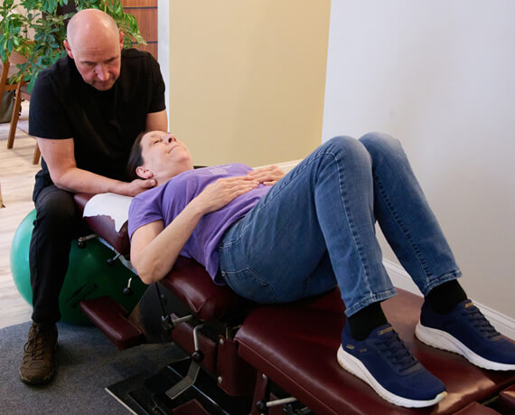 Stratham chiropractor Dr Bart adjusting patients shoulder